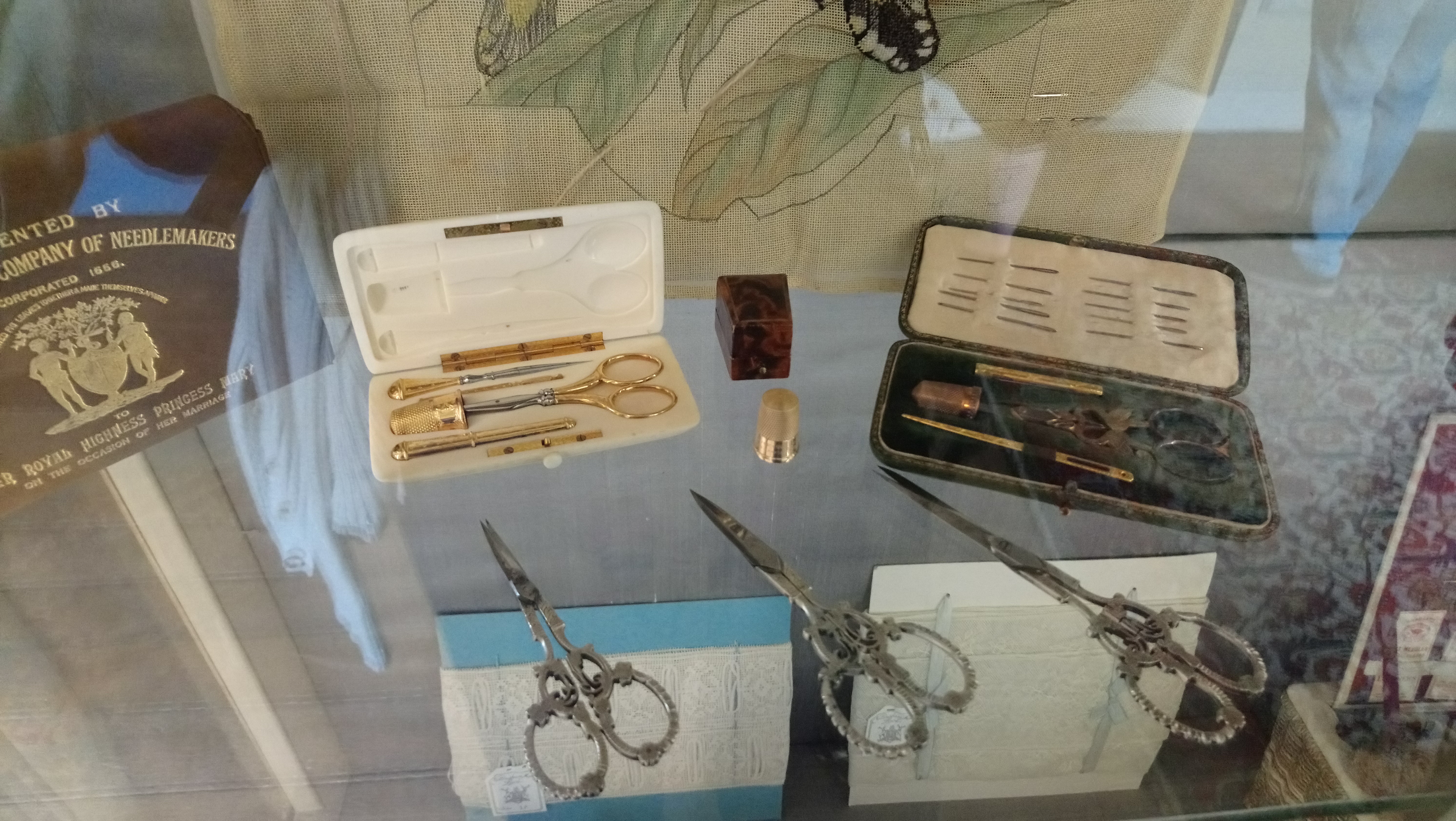 Vintage sewing tools, such as thimbles, needle-cases and decorative scissors on display at Harewood House, Yorkshire