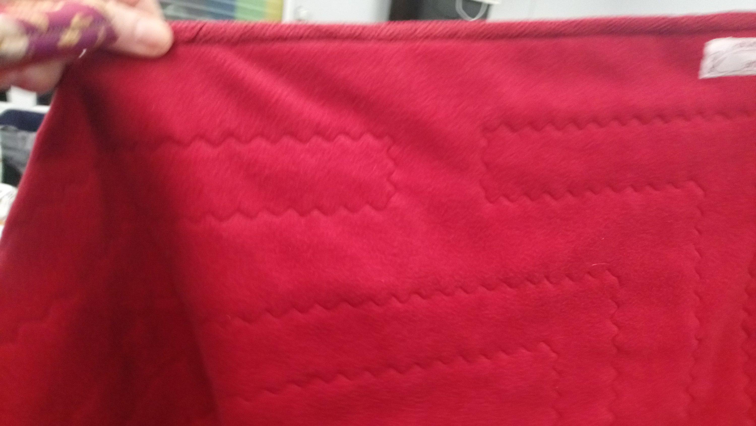 the reverse of a quilt showing the quilting stitches