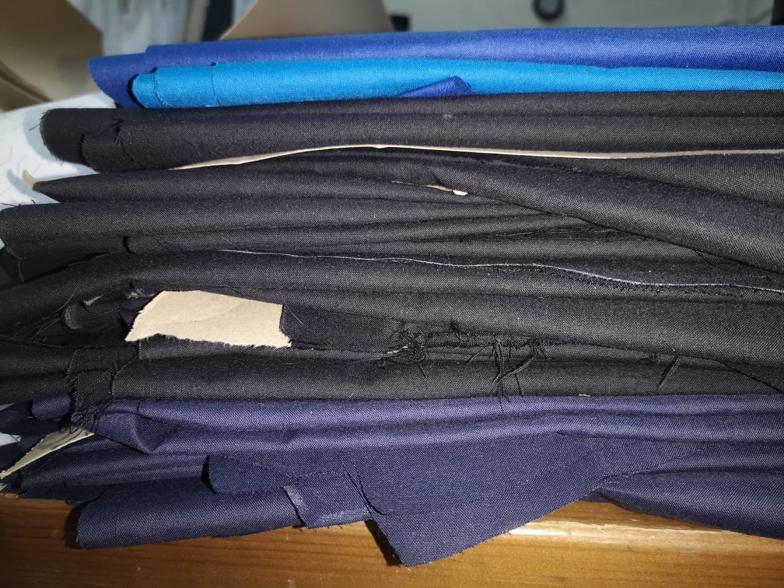 a pile of fabrics which will be made into NHS scrubs by Aimee Veitch