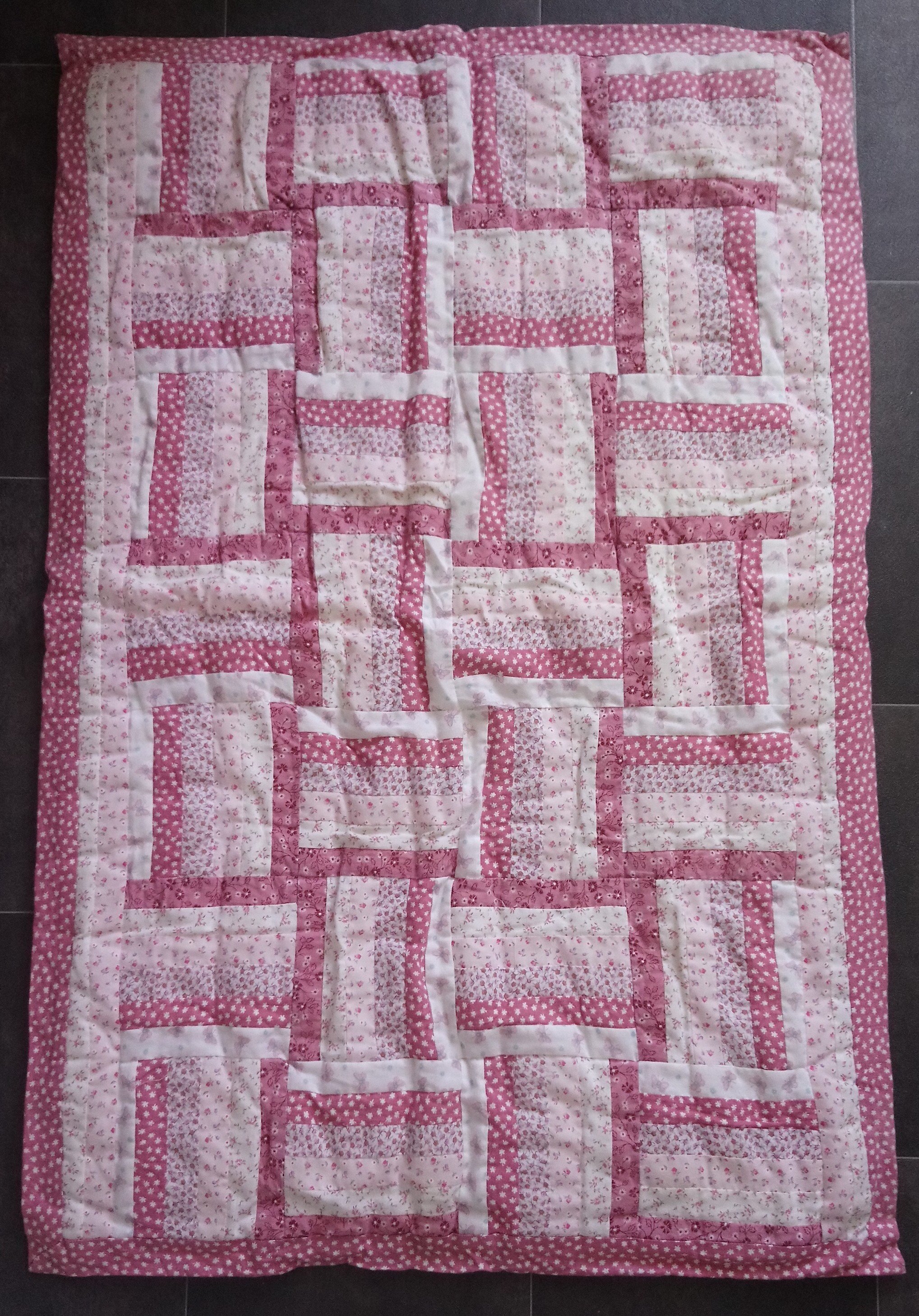 reverse of a quilt showing strip-pieced blocks
