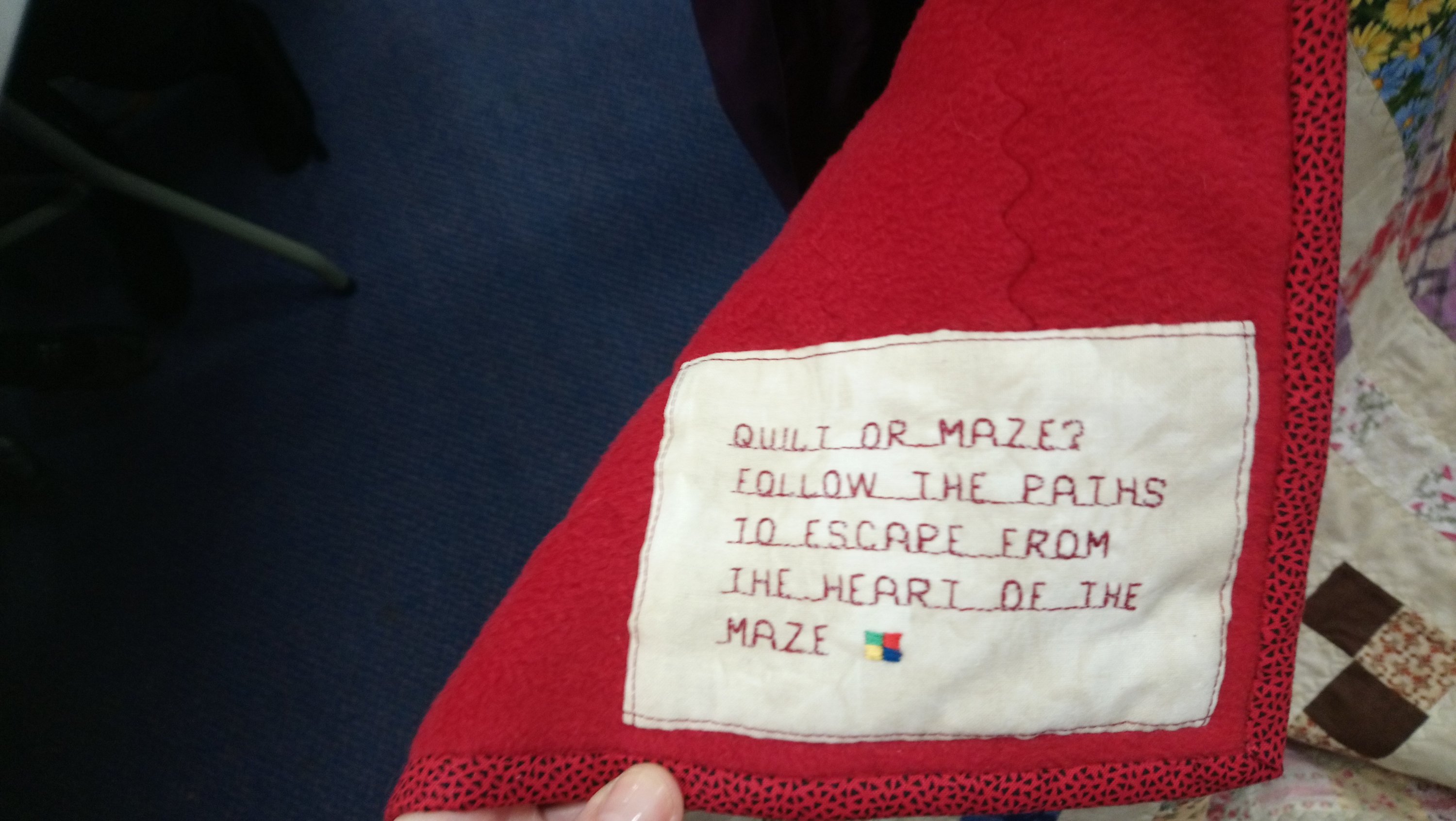 a quilt label explaining that the quilt is a puzzle maze