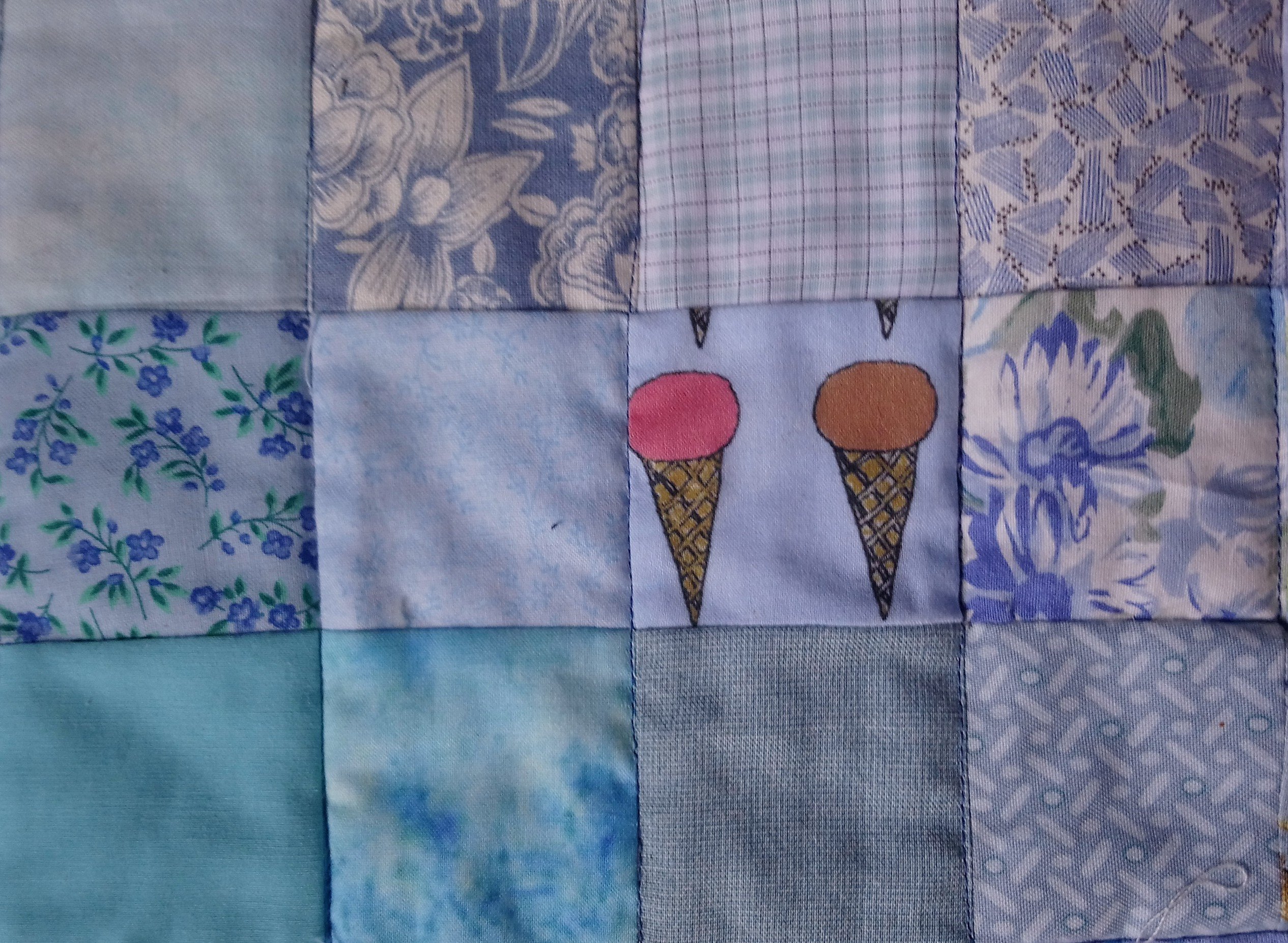 A quilt of blue squares including Ice Cream Please by Amanda Jane Textiles