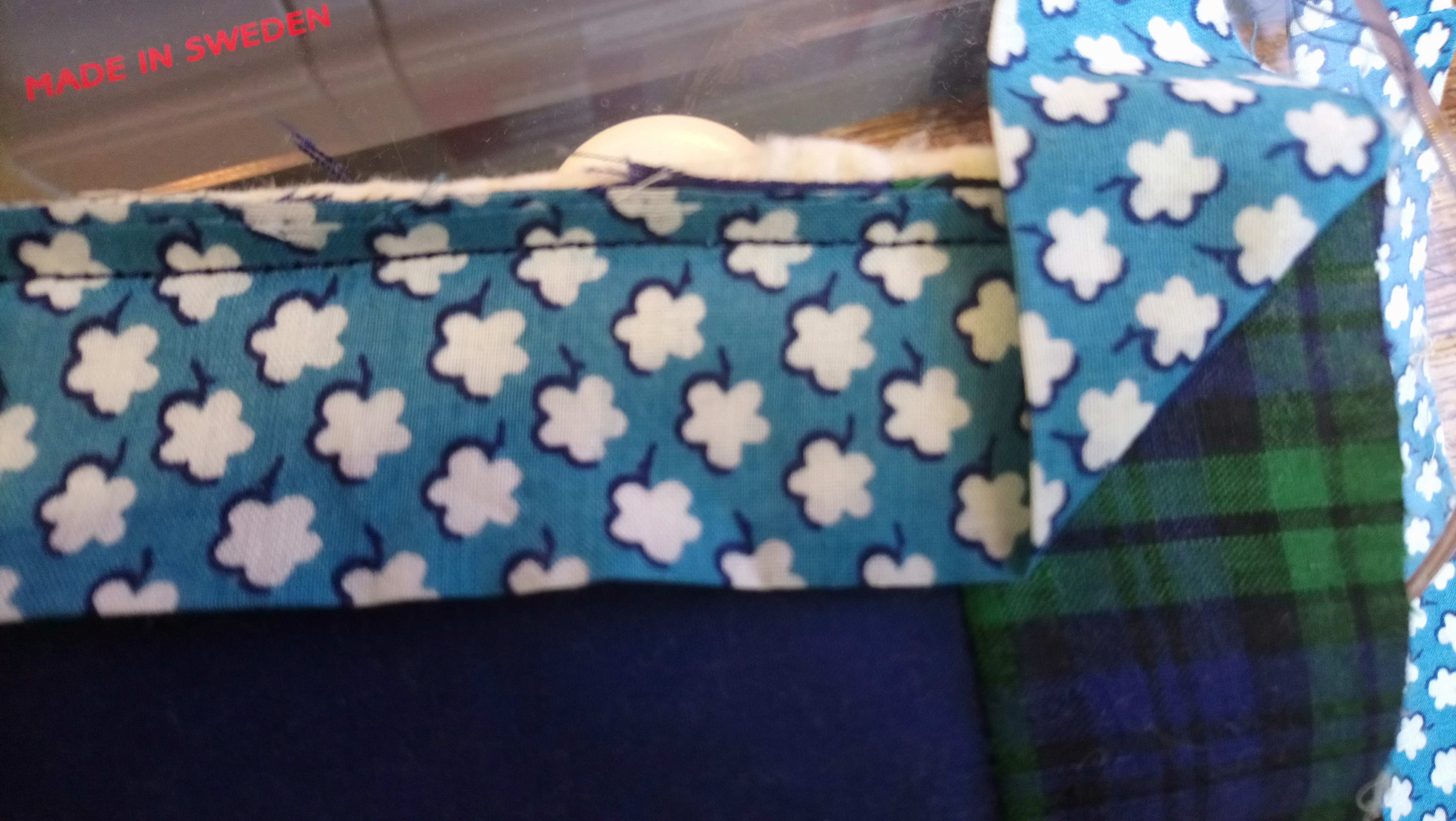 Folding up the corner of a quilt binding