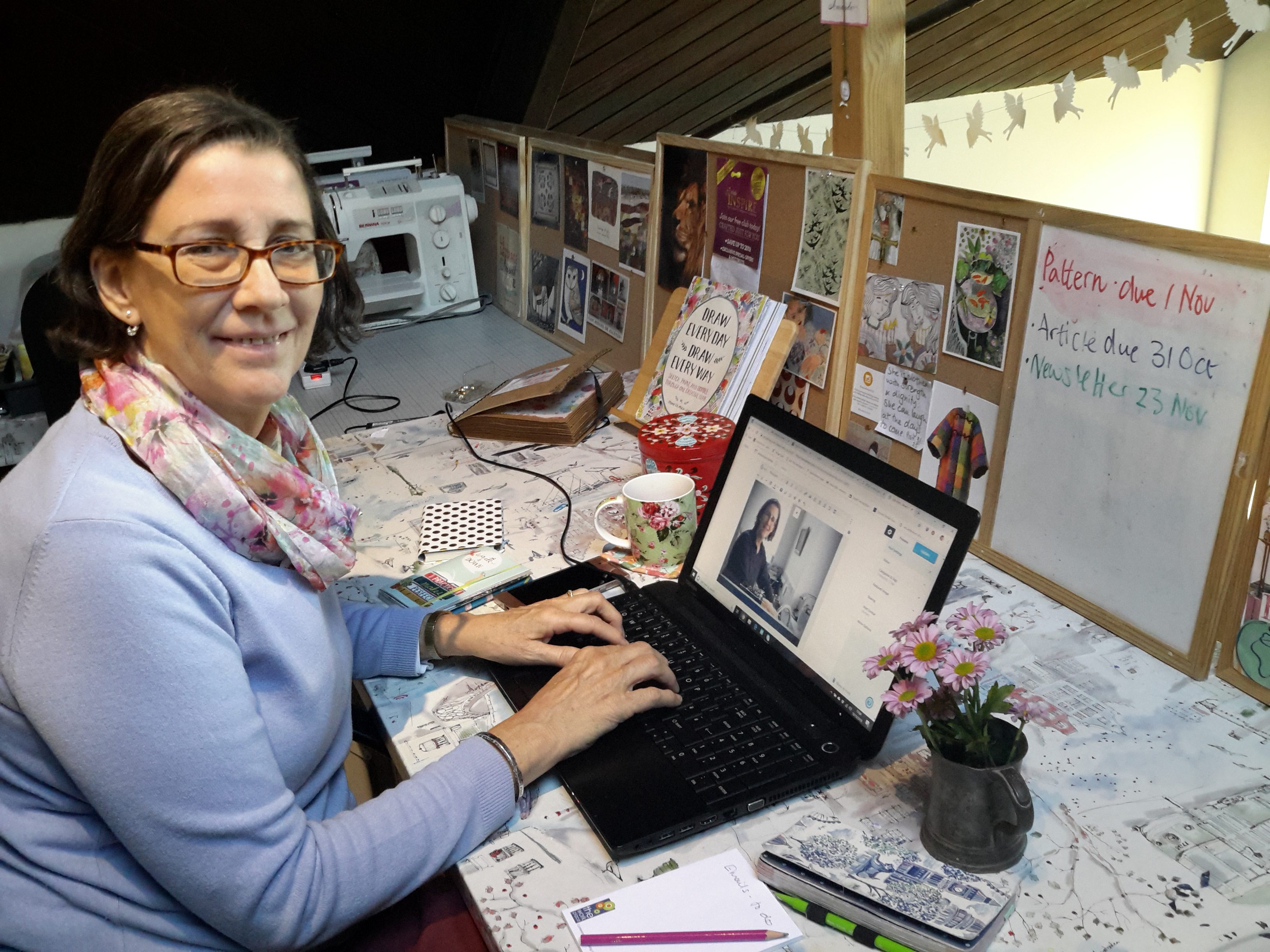 Amanda Ogden working on her laptop, writing the weekly blog post
