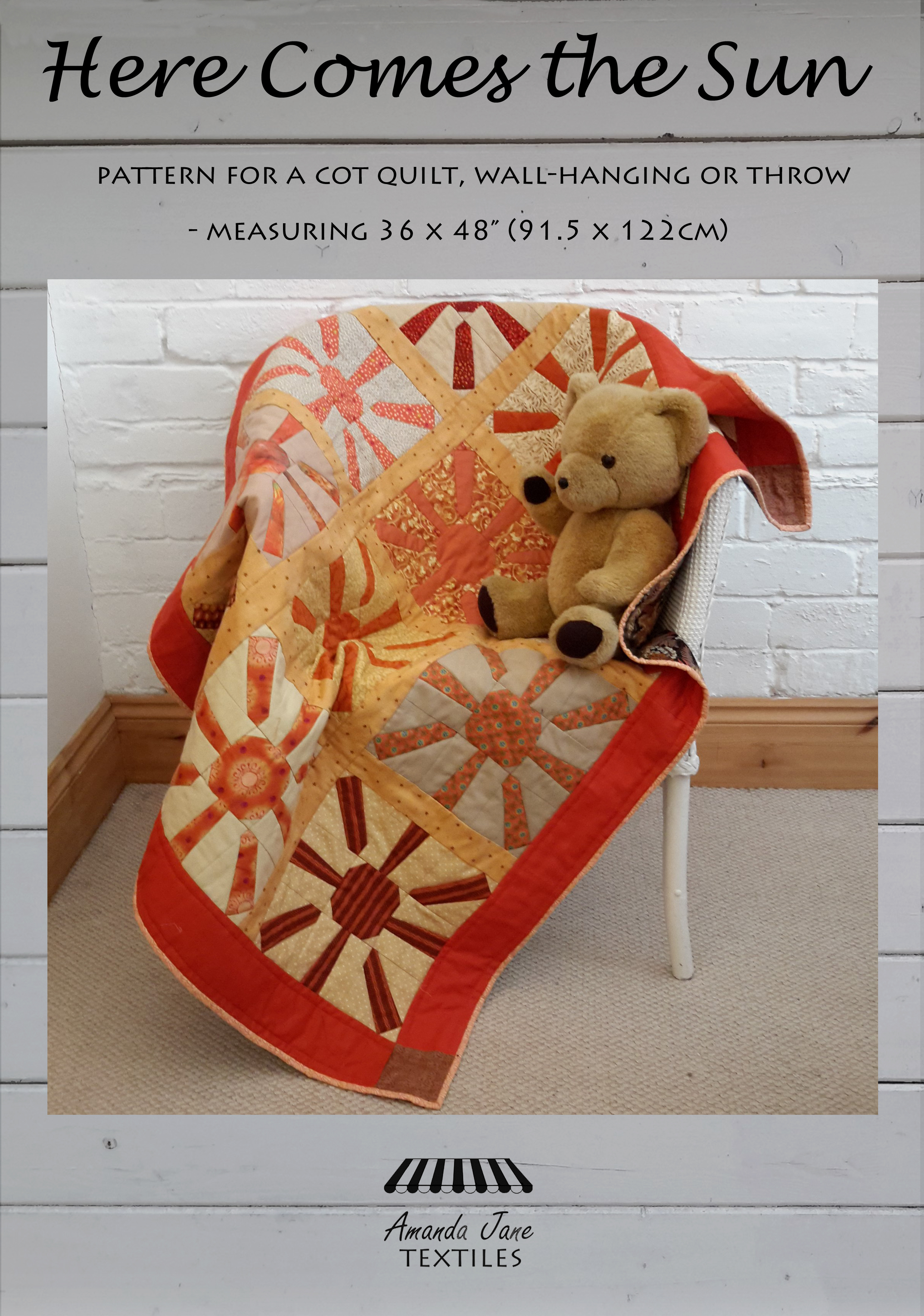 a cot quilt in oranges and yellows called 'Here Comes the Sun'