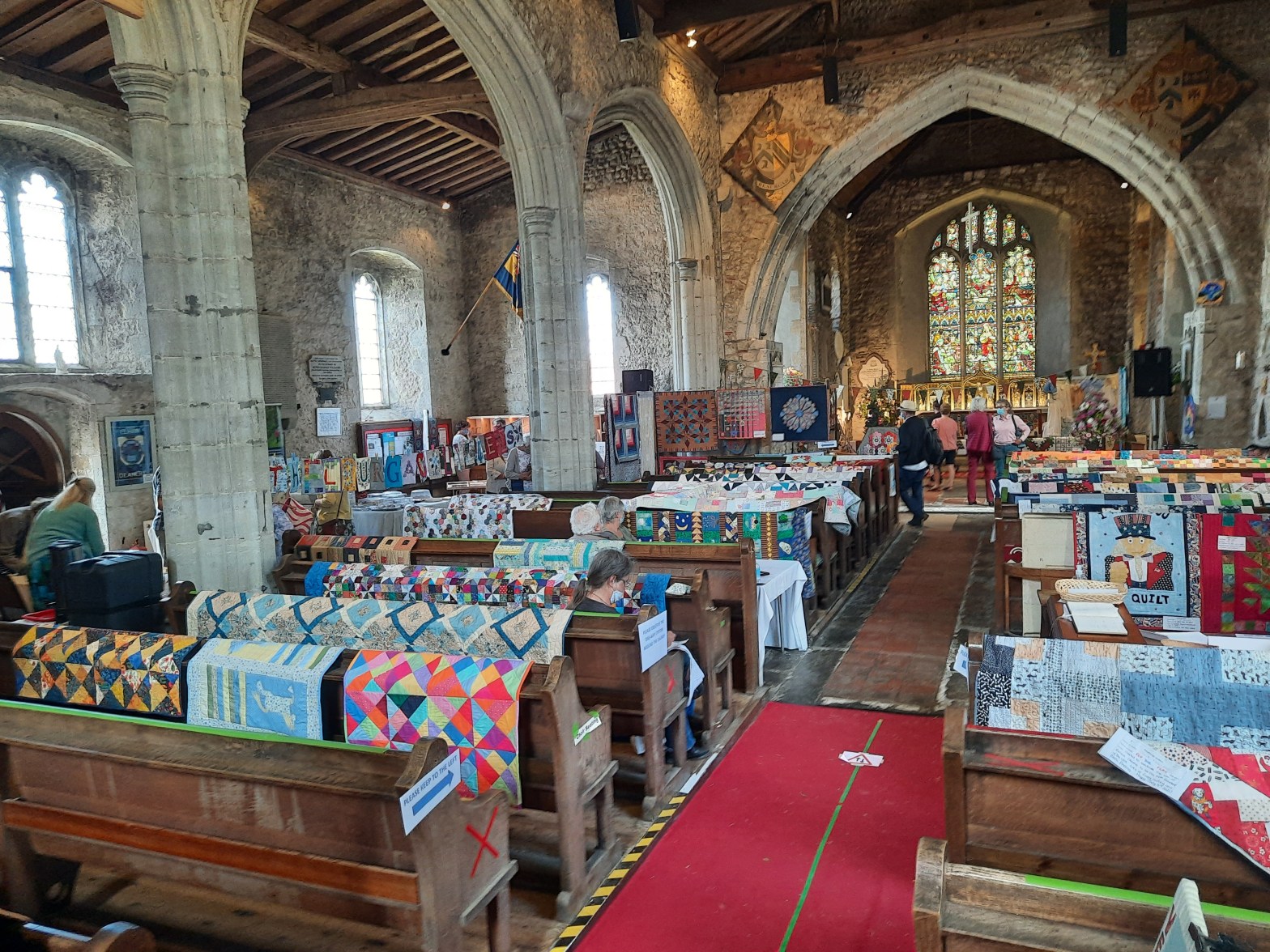 The interior of a church being used for Ethelburga's quilt show, Lyminge, 2021
