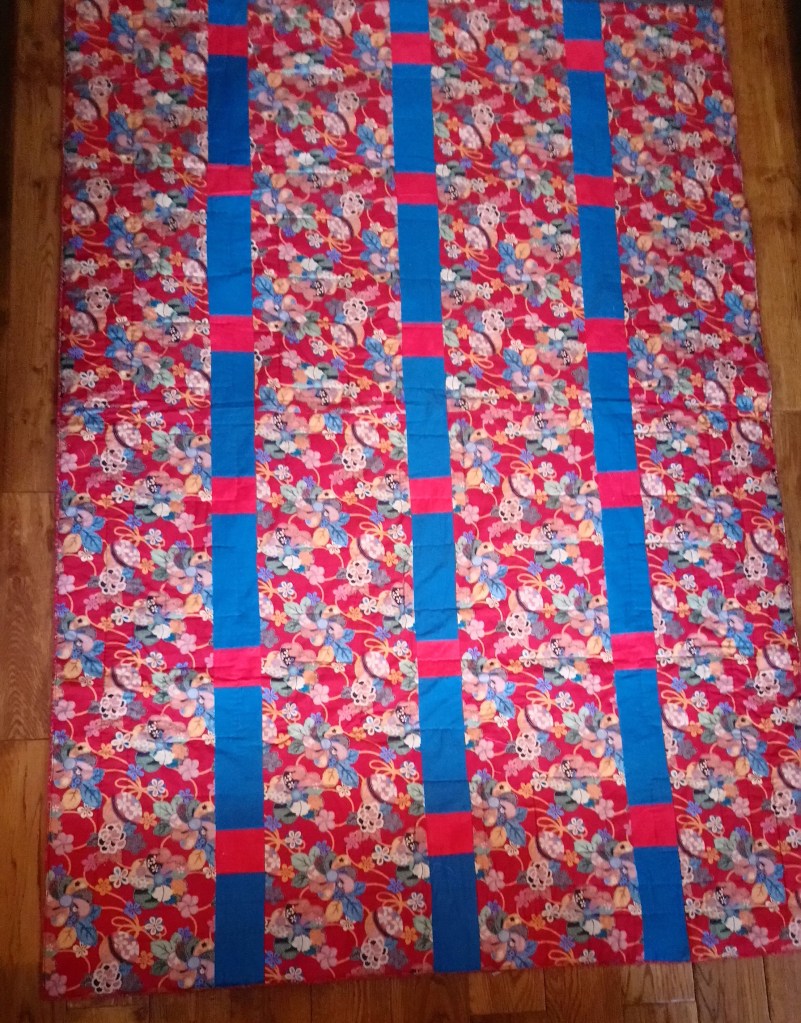 Photo of a quilt to show how inserting strips adds to the width