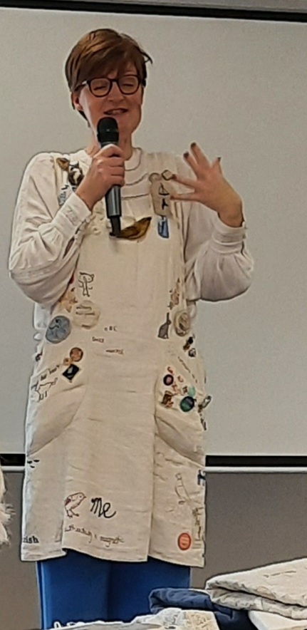 Designer Janet Clare wearing her embroidered apron