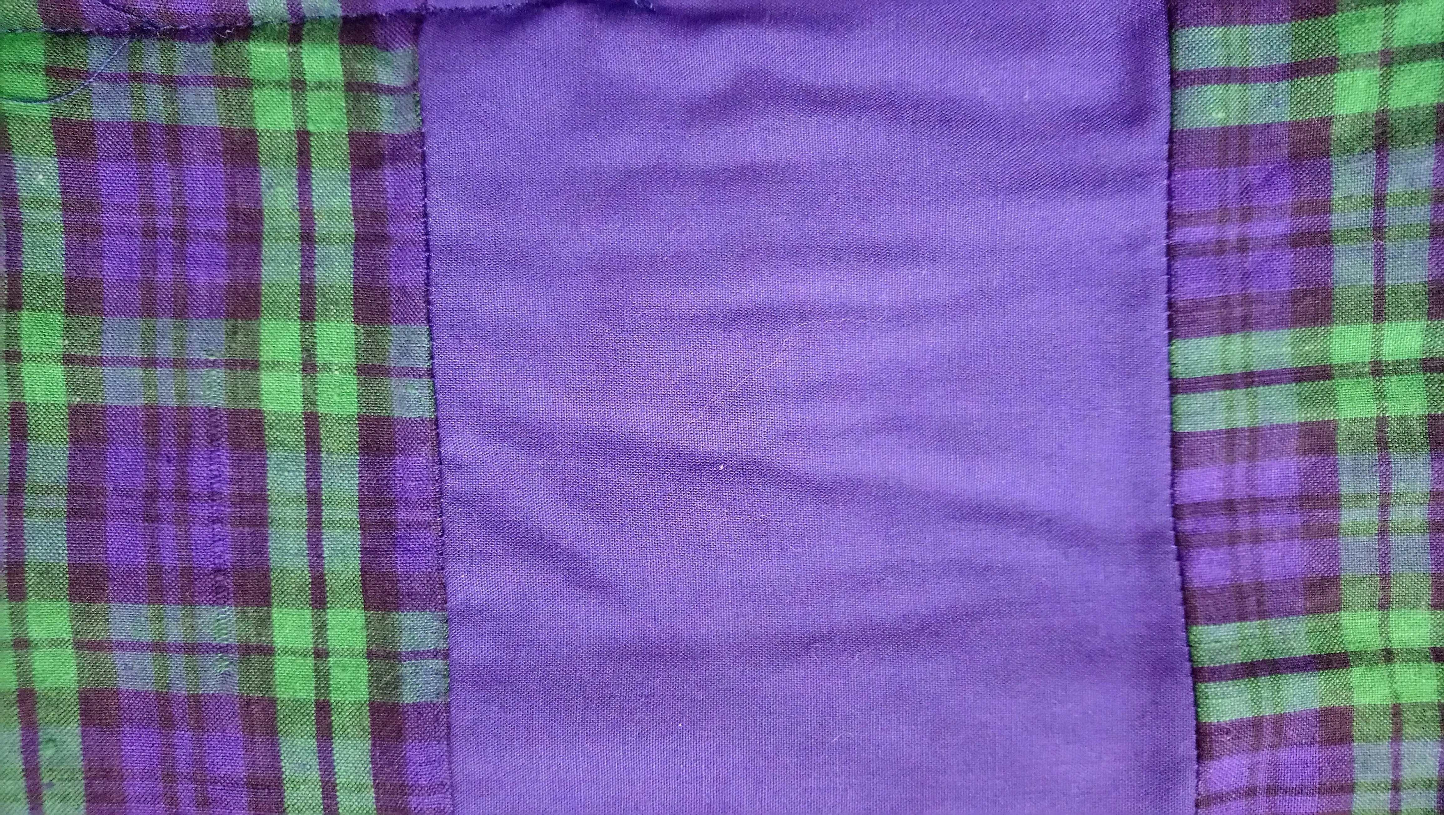 Photo showing how to insert a strip into a quilt back to make it wider