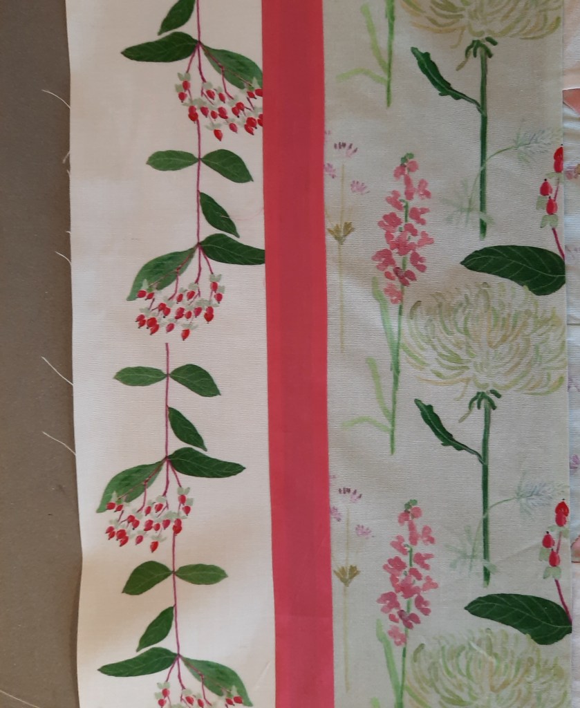 The outer border on the left side of the 'Summer Bouquets' quilt, the outer border uses the 'Berries on White' fabric design which is of red berries in a sprig with green leaves