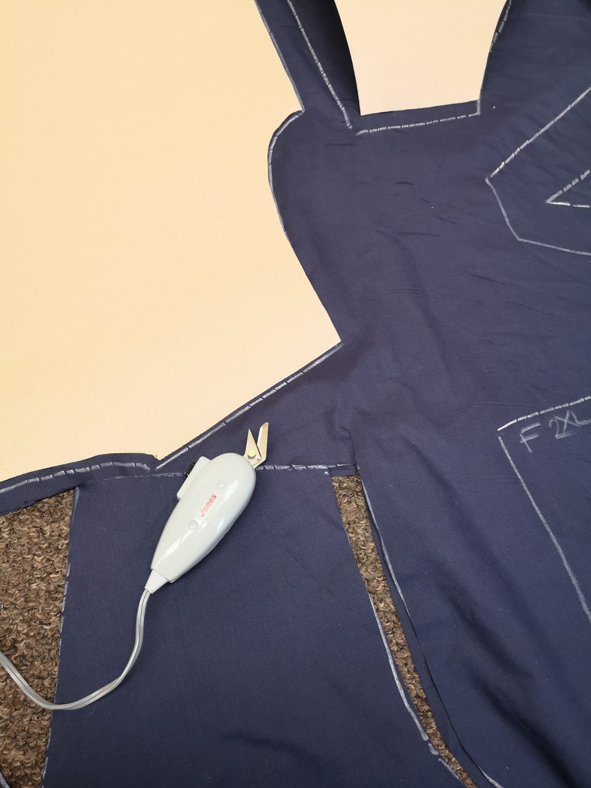 fabric being cut out to make hospital scrubs