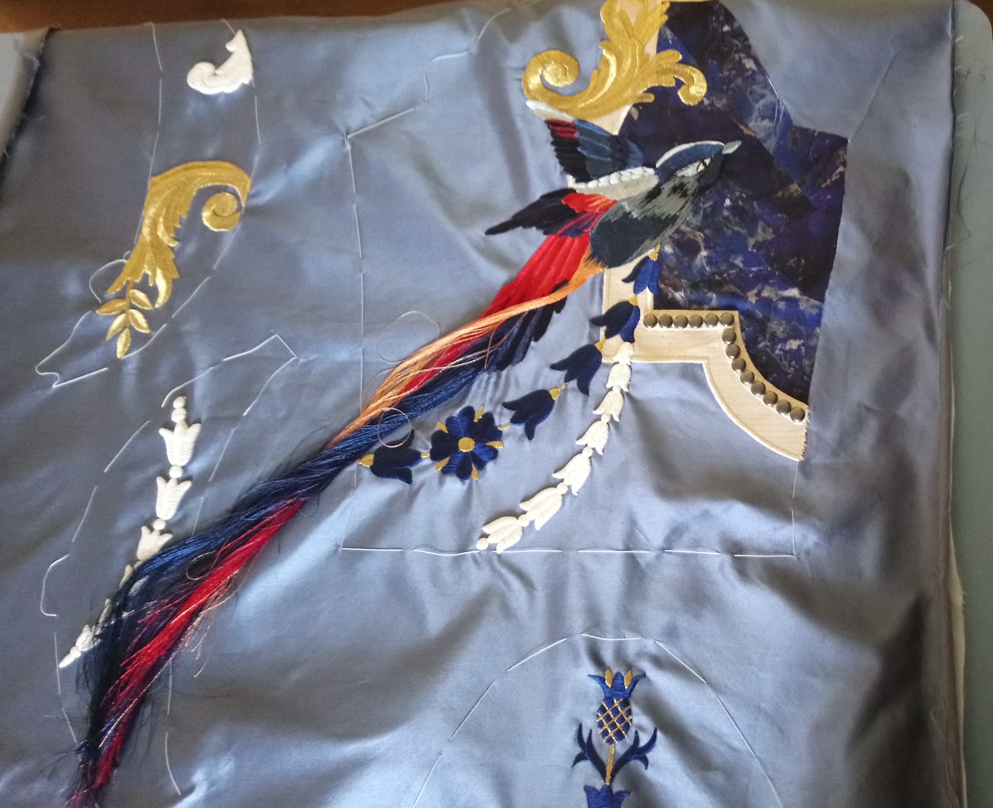 Embroidery sample depicting a bird and decorative frames by Jenny King