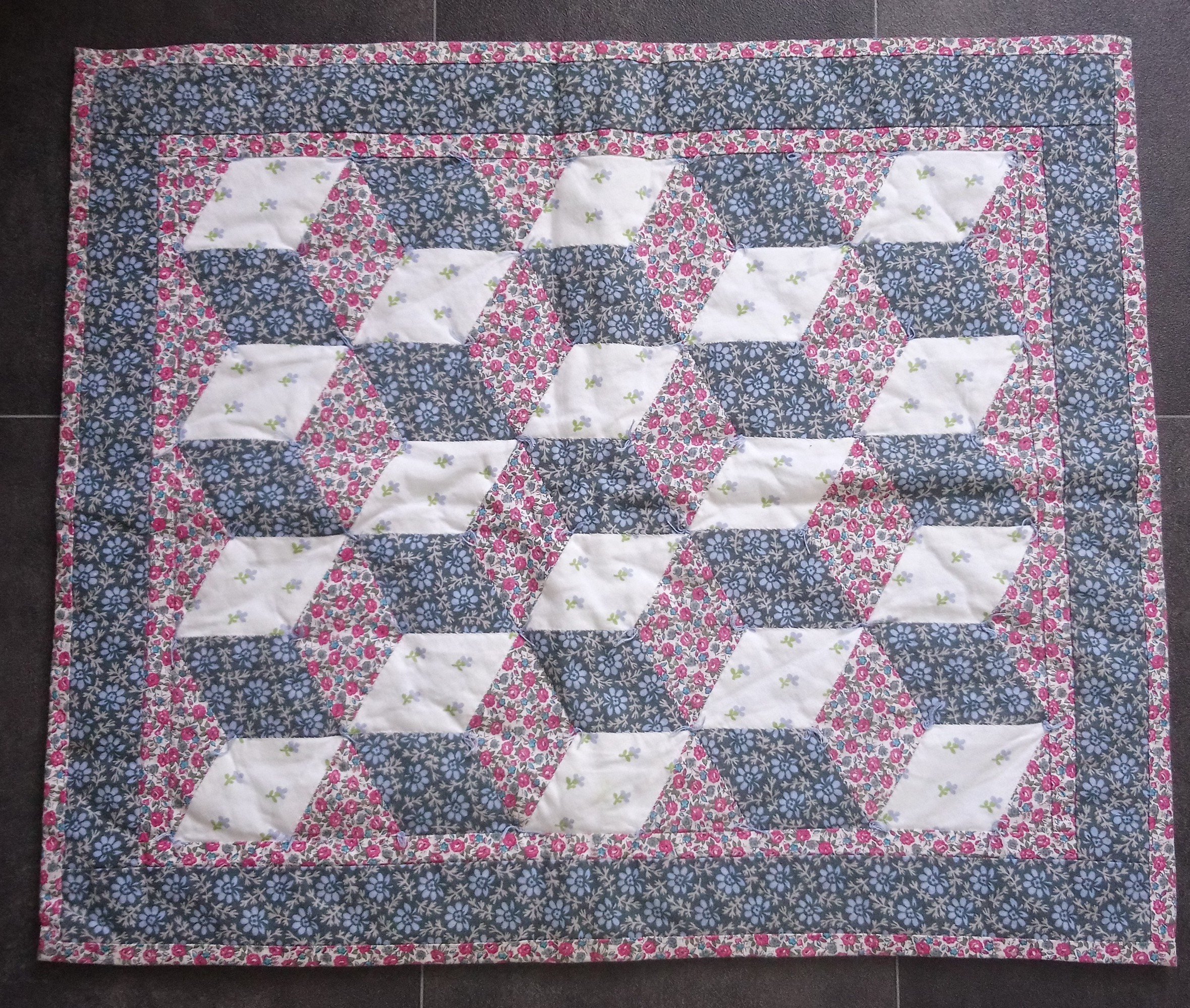 small quilt made with 'baby blocks' design in pink blue and white
