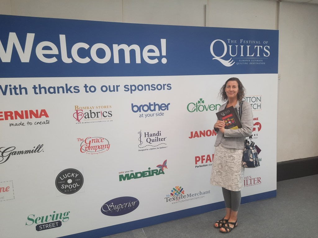 Amanda Jane Ogden at the entrance to the Festival of Quilts 2021
