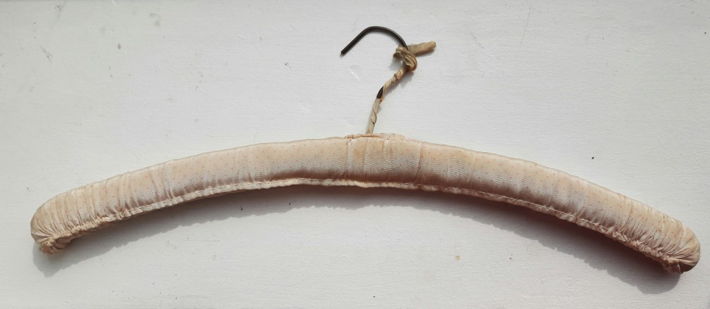 a coathanger covered in vintage fabric