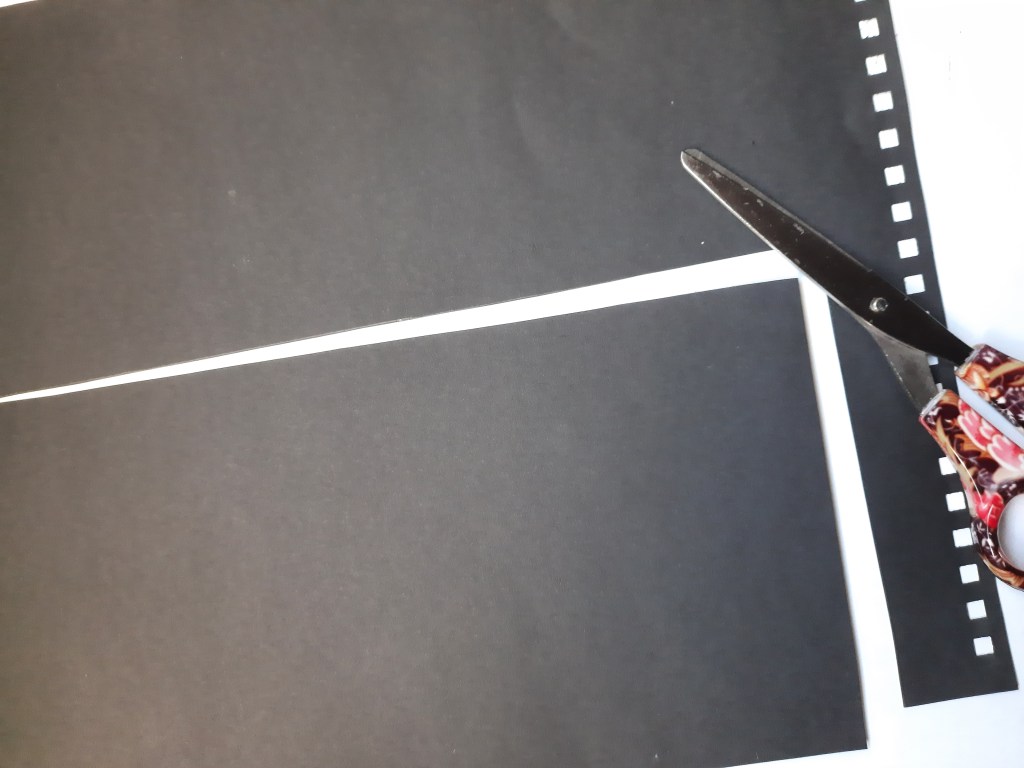 cutting out cardboard to make a card