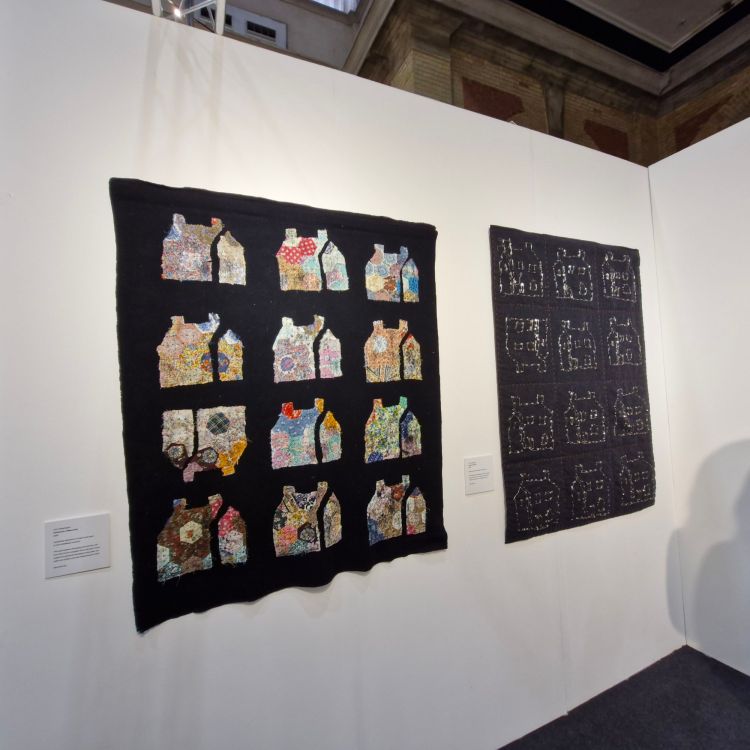 Pair of quilts on the wall of Lynn Setterington's stand at Knit and Stitch 2025