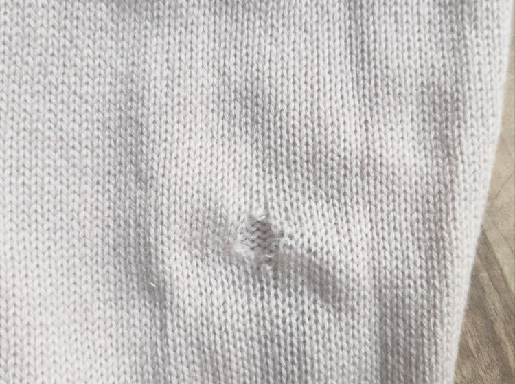 a hole in the sleeve of a cashmere cardigan