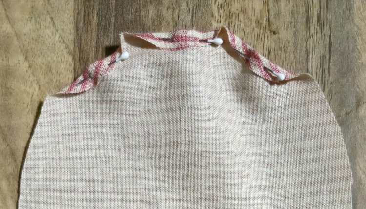 Starting to pin a narrow fold around the patch
