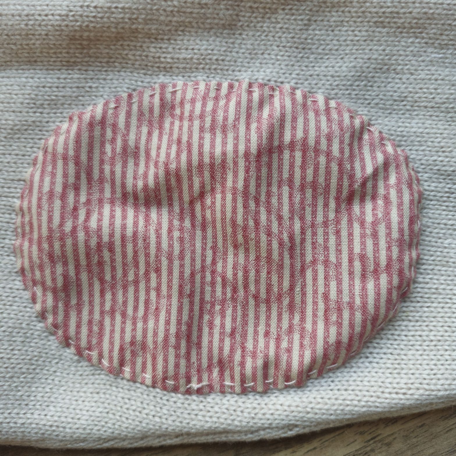 A patch on a cardigan sleeve