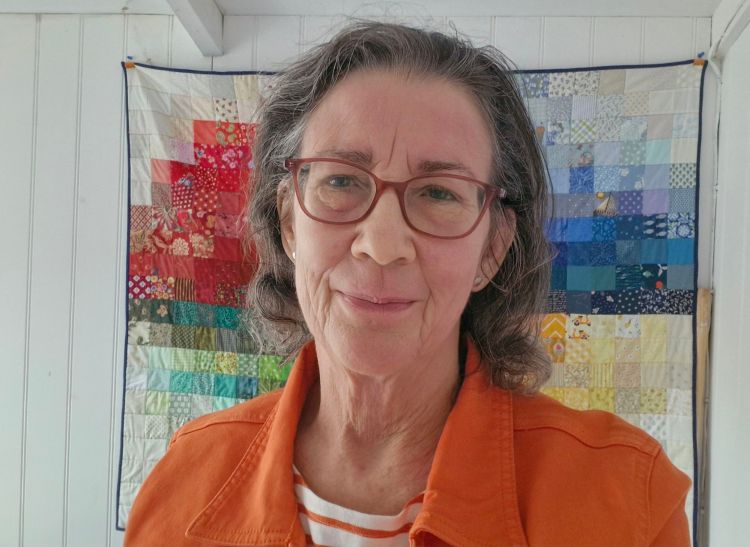Amanda Jane Ogden in her studio in front of her 'Colour Mosaic' quilt